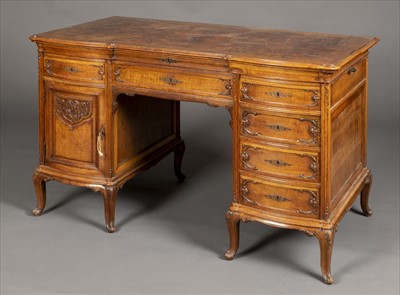 Lot 127 - Desk. A Continental walnut and figured walnut Rococo style kneehole desk, circa 1900