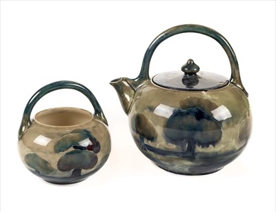 Lot 10 - Moorcroft. A Moorcroft pottery 'Moonlit Trees' pattern teapot and sugar bowl