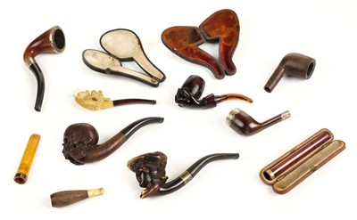 Lot 144 - Pipes. A collection of Victorian and later pipes including a skull pipe