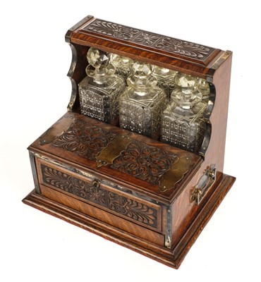 Lot 161 - Tantalus. A Victorian oak three bottle tantalus