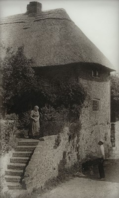 Lot 135 - Diapositive on glass. An elderly woman conversing with a neighbour outside her cottage, c. 1920