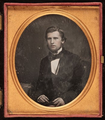 Lot 30 - Daguerreotypes. A one-quarter plate daguerreotype of a seated young woman holding a book, circa 1860