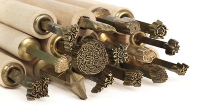Lot 343 - Decorative finishing tools. 21 brass decorative finishing tools, decorative roll etc.