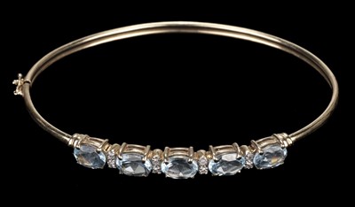Lot 468 - Bangle. 9ct gold bangle, set with 5 topaz stones