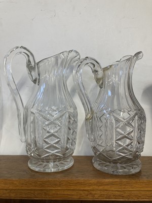 Lot 558 - Jugs. A near pair of Edwardian Waterford crystal glass jugs, circa 1910
