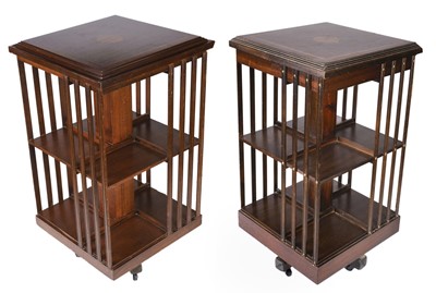 Lot 627 - Bookcases. A matched pair of Edwardian style mahogany inlaid revolving bookcases