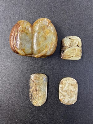 Lot 487 - Jade. A Chinese jade boulder, carved as two fruit with a bat to the right and other carvings