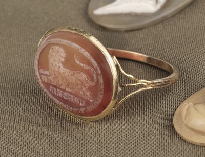 Lot 455 - Grand Tour. A yellow metal ring set with a carved oval carnelian stone
