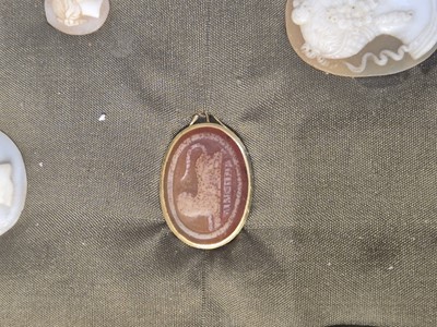 Lot 455 - Grand Tour. A yellow metal ring set with a carved oval carnelian stone