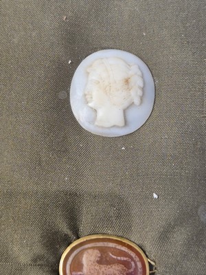 Lot 455 - Grand Tour. A yellow metal ring set with a carved oval carnelian stone