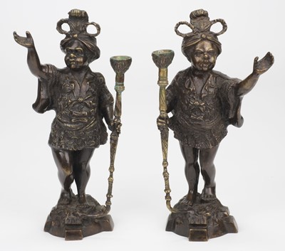 Lot 706 - Blackamoors. A pair of cast bronze Blackamoor candlestands, 20th century