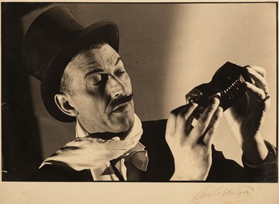 Lot 50 - Beaton (Cecil, 1804-1980). Portrait of a magician playing a concertina accordion, c. 1930