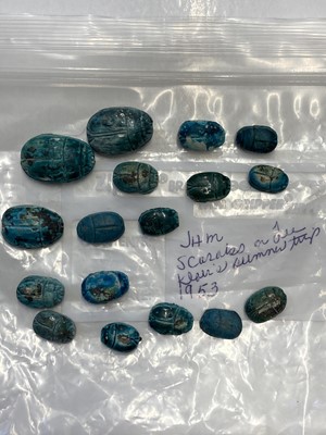 Lot 647 - Scarabs. A collection of 17 Egyptian faience scarabs and 10 North American flint arrowheads