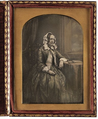 Lot 127 - Dagurreotype. Large half-plate daguerreotype of a lady seated at a table, c. 1855