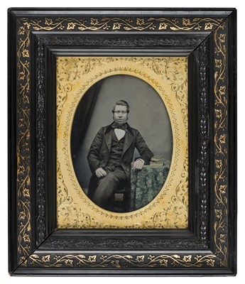 Lot 480 - Half-plate ambrotype of a gentleman seated at a table