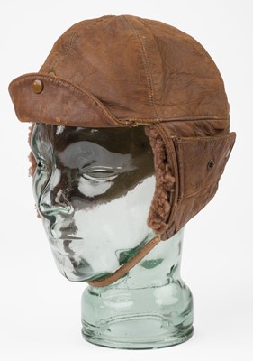 Lot 145 - Flying Helmet. A WWI Royal Flying Corps brown leather flying helmet with integral goggles