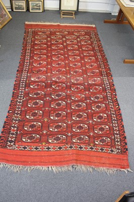 Lot 265 - Carpets. A large Oriental Bochara woollen carpet, 20th century, and two others