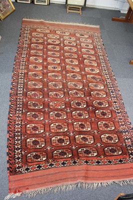 Lot 265 - Carpets. A large Oriental Bochara woollen carpet, 20th century, and two others