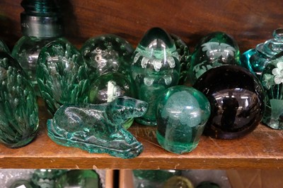 Lot 401 - Paperweights. A large collection of Victorian green glass dump paperweights