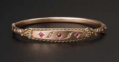 Lot 439 - Bangle. An Edwardian 9ct gold garnet and diamond bangle