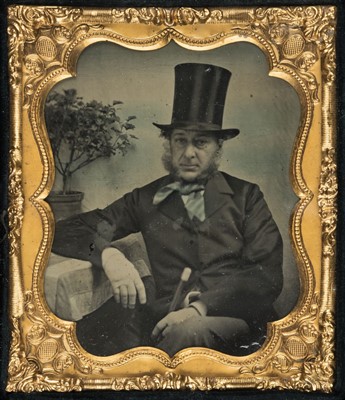 Lot 322 - Sixth-plate ambrotype portrait of a seated gentleman with a top hat